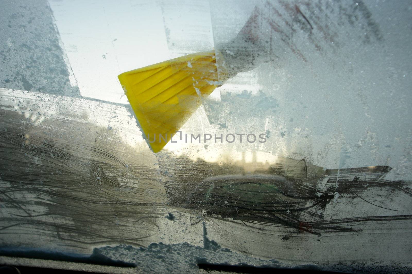 car windshield covered with ice and snow