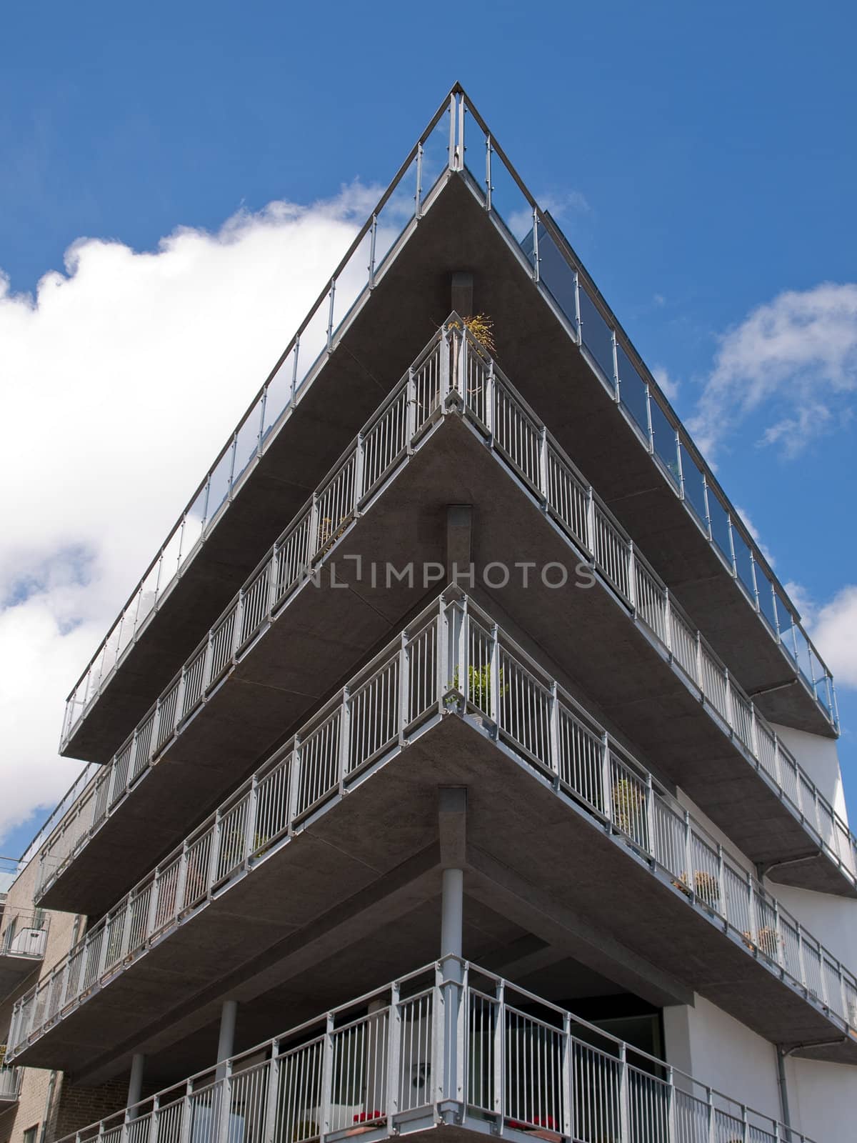 Modern apartments building architecture background vertical by Ronyzmbow