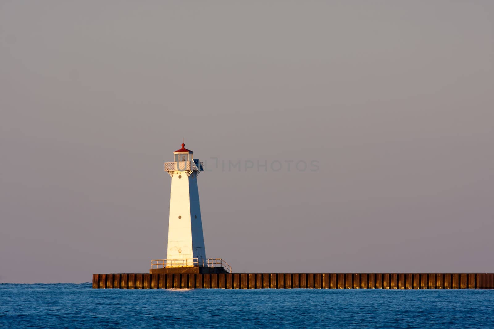 Sodus Bay Lighthouse on Lake Ontario in evening light at sunset