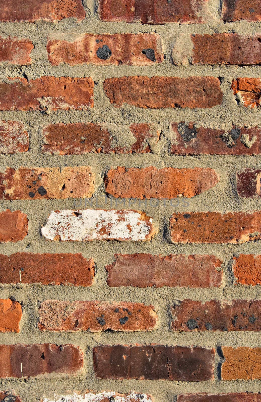 Red brick wall showing detail, patterns, and texture in portrait format