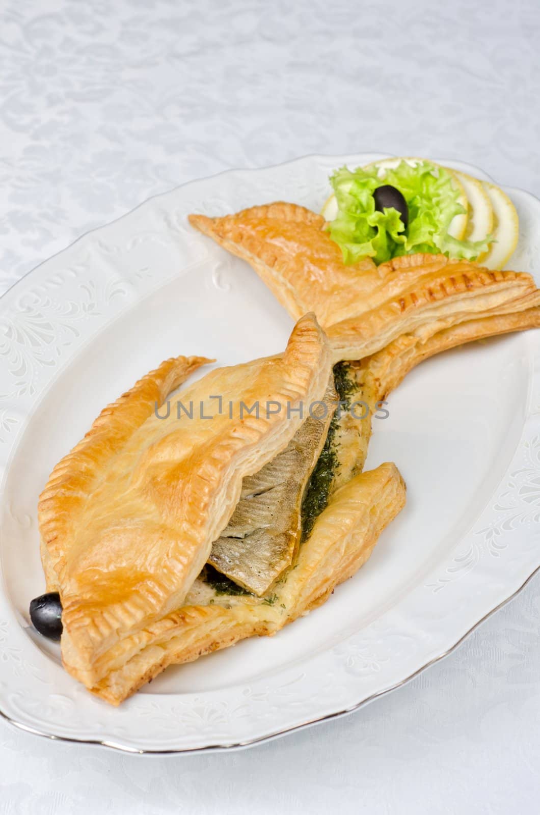 tasty dish of trout fish baked with greens at dough