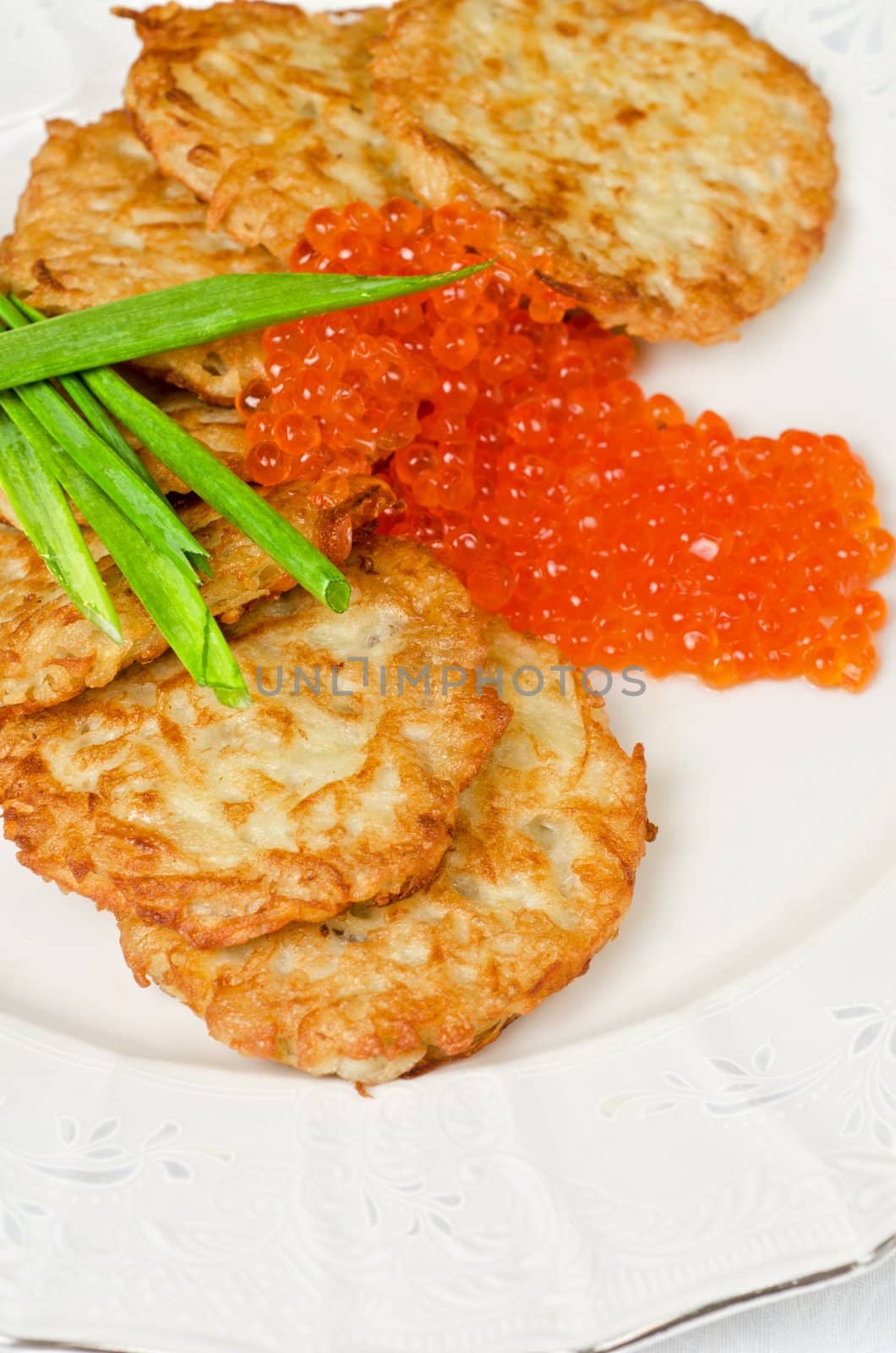 pancakes with red caviar and green onion closeup dish