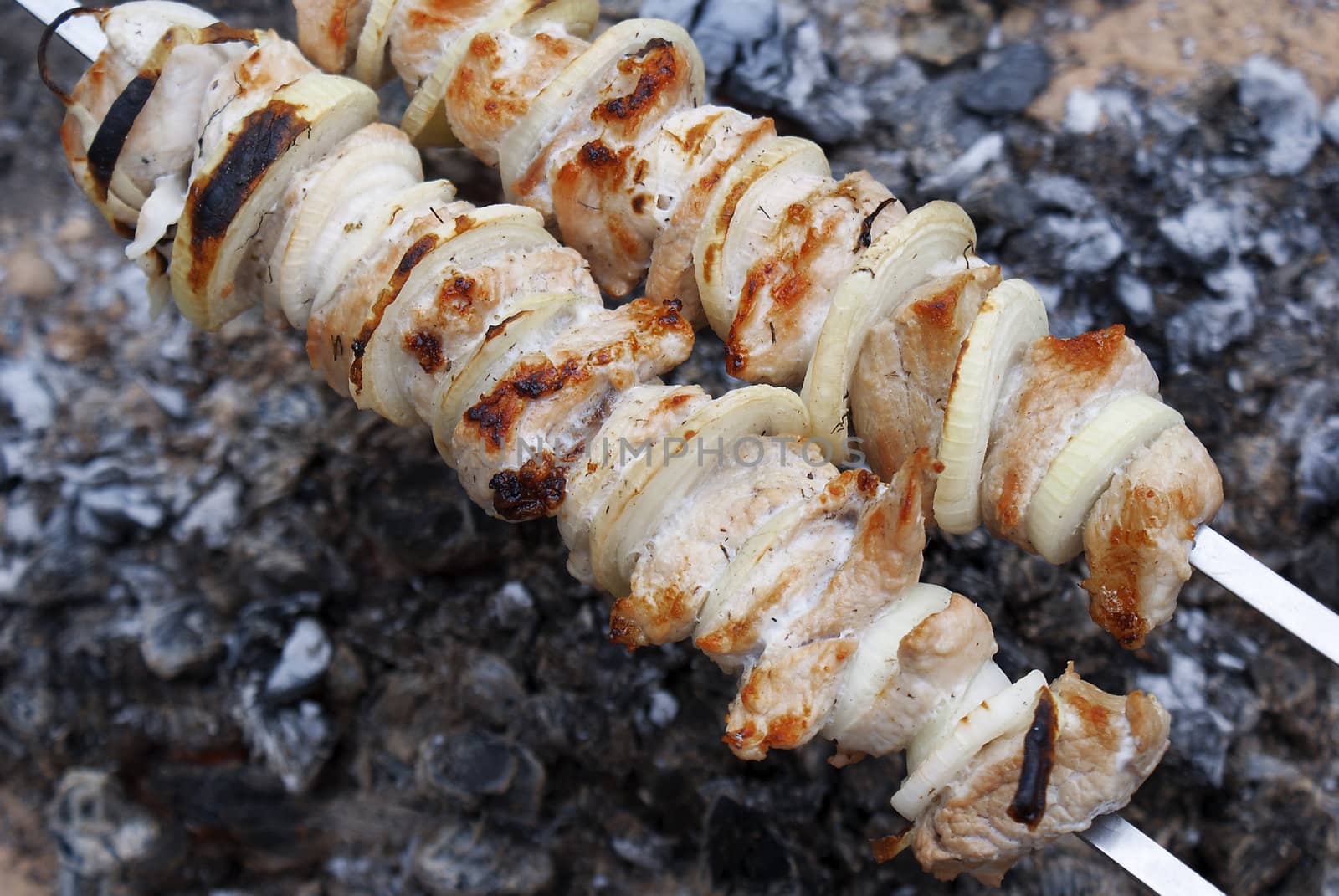 Appetizing juicy shish kebab from fresh pork prepared on coals