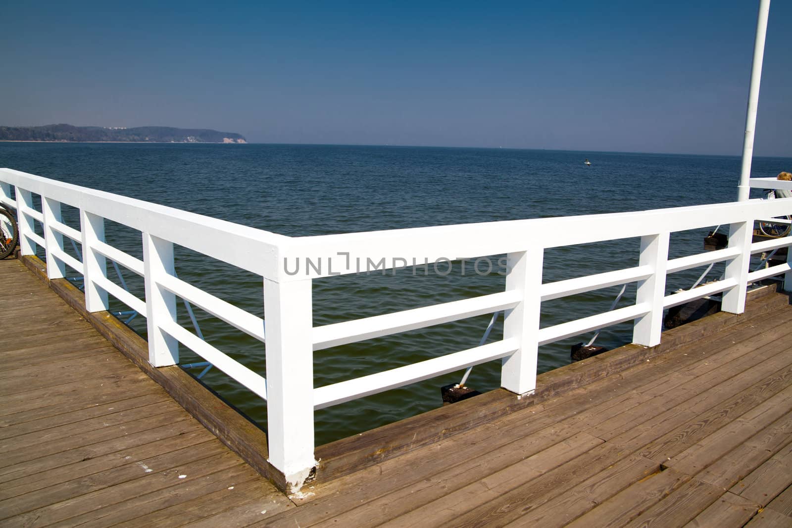 A wooden pier white barriers
