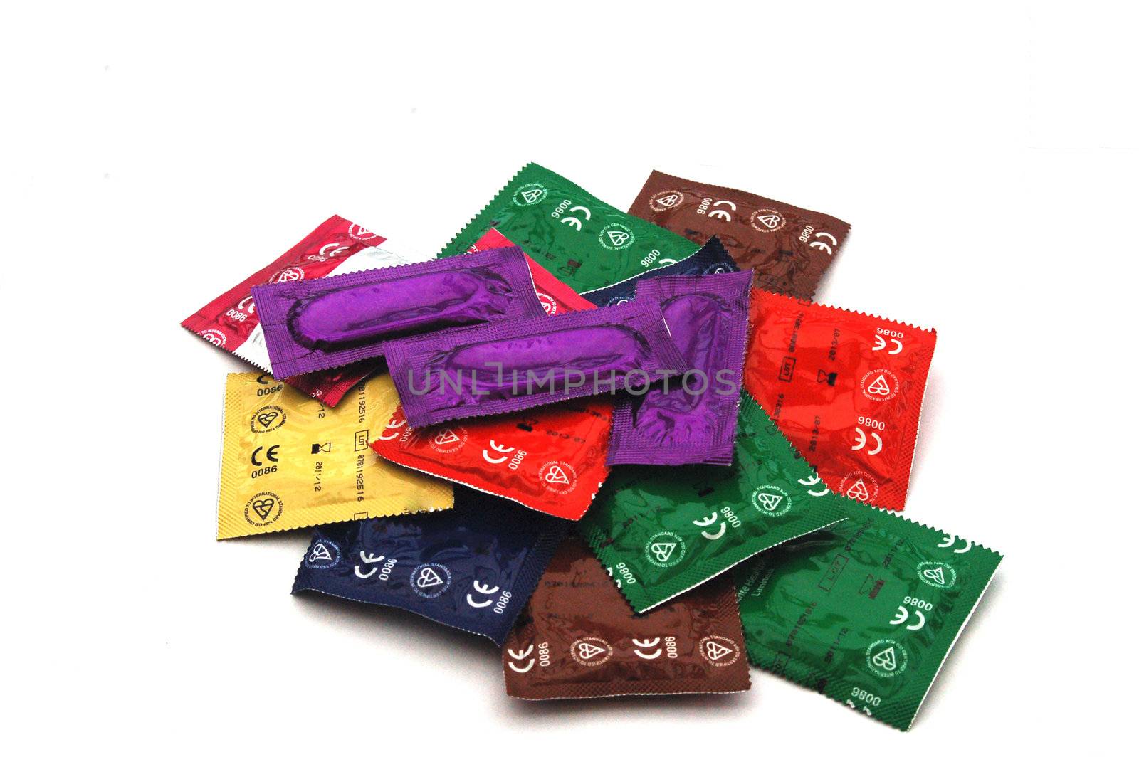 Brightly Coloured Condom Packs on white Background. These do not have makers Markings, just British Standard Kite Marks and European Standard Mark, so suitable for any use.