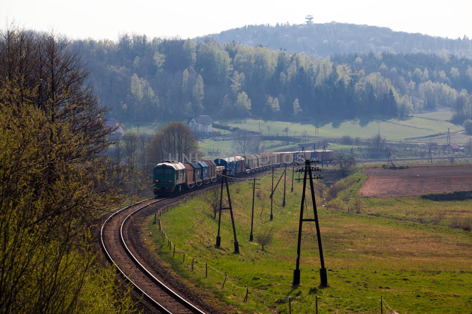 Freight train passing the hilly landscape
