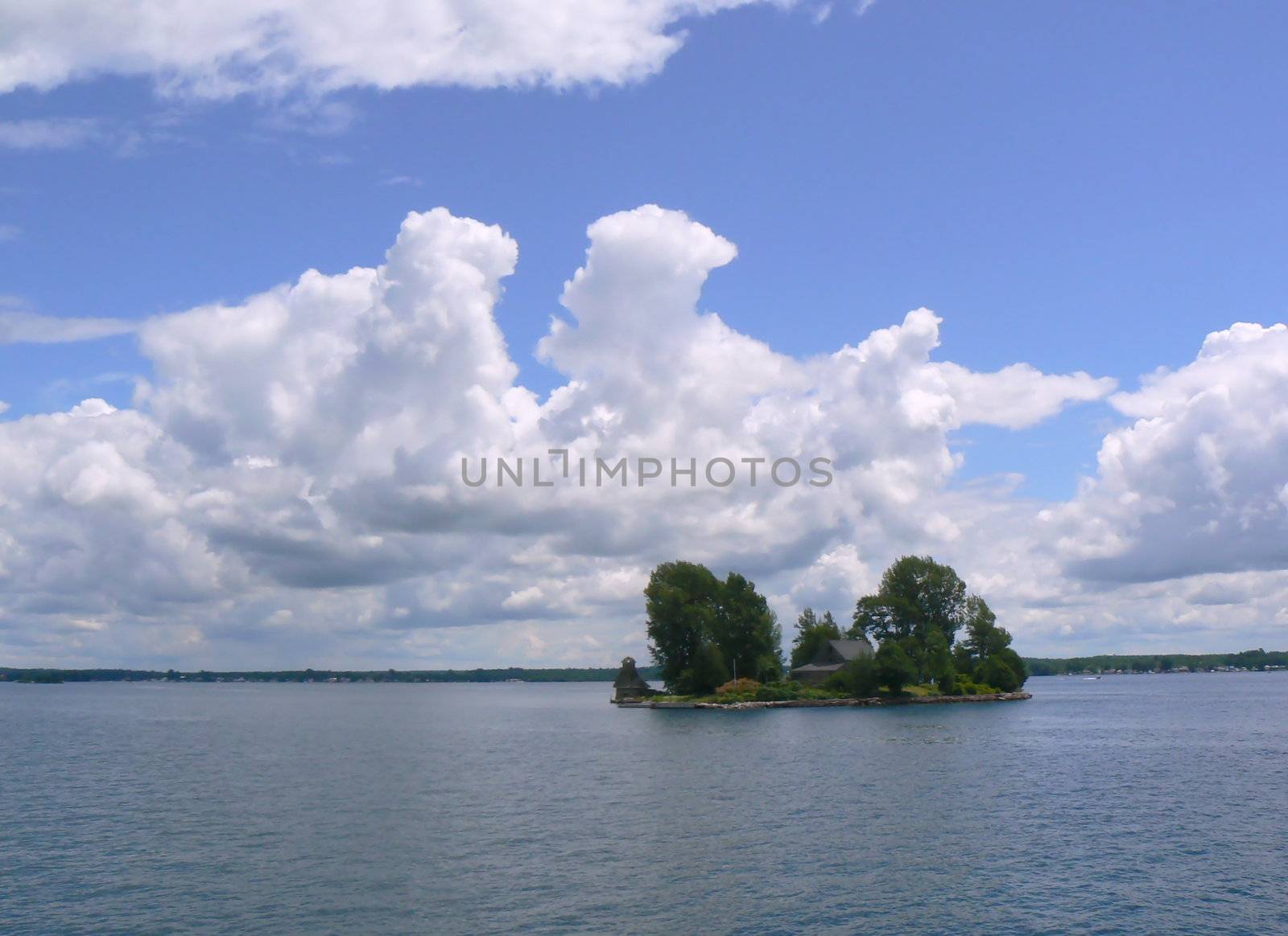 Small island with a house in the middle of thousand islands on Ontario lake, Canada, by cloudy weather