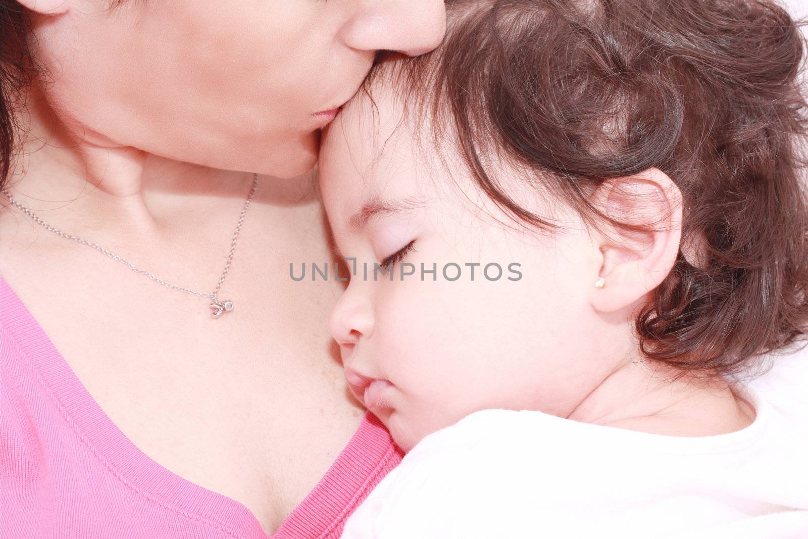 delighted young mother taking care of her adorable baby at home