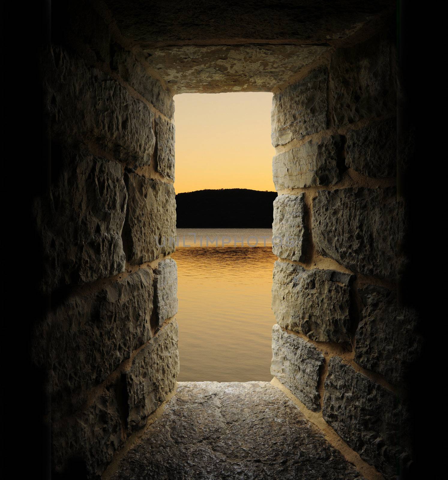 Viewing a lake or moat through a stone castle-like window. Vertical