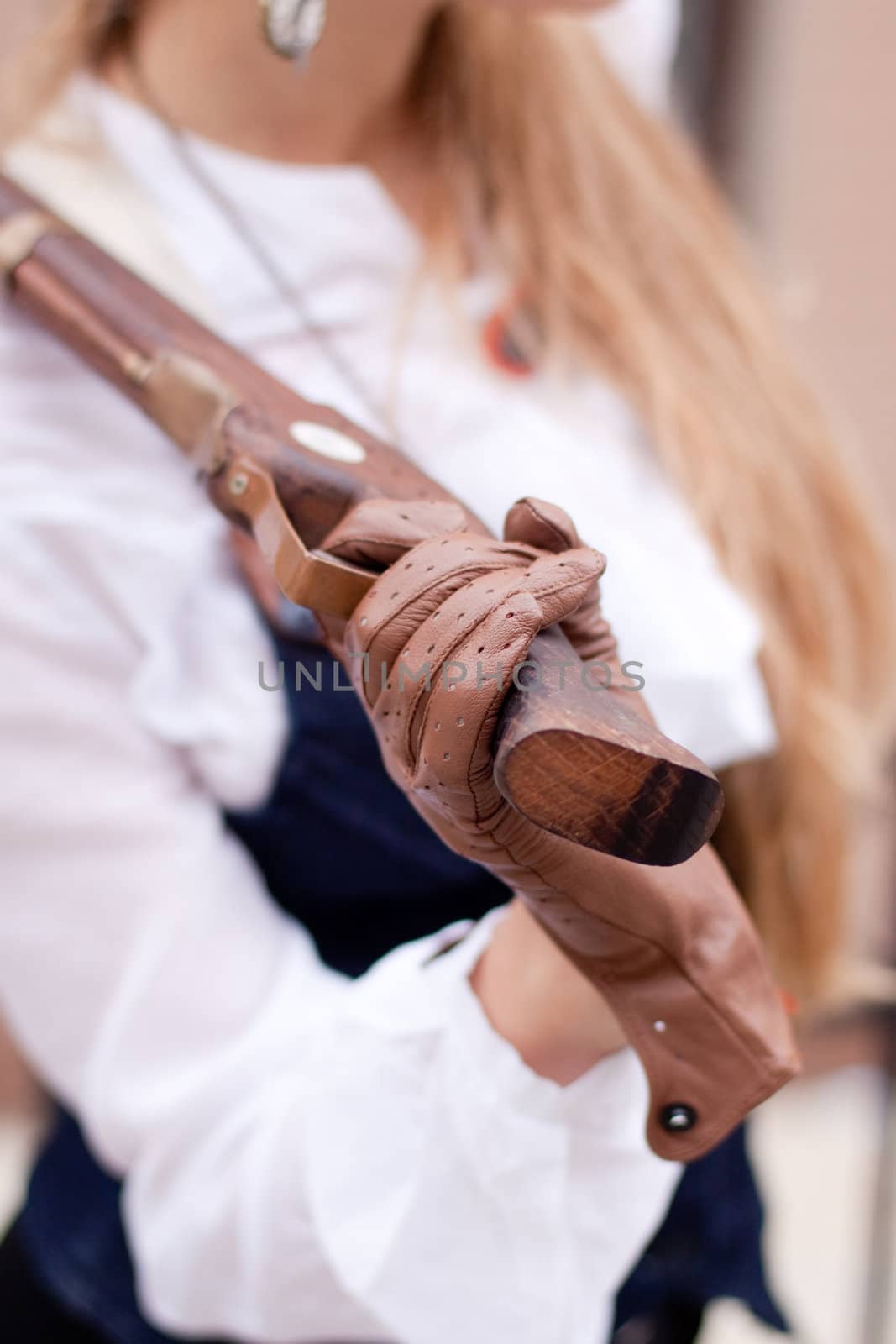 A women handing an old pistol 
