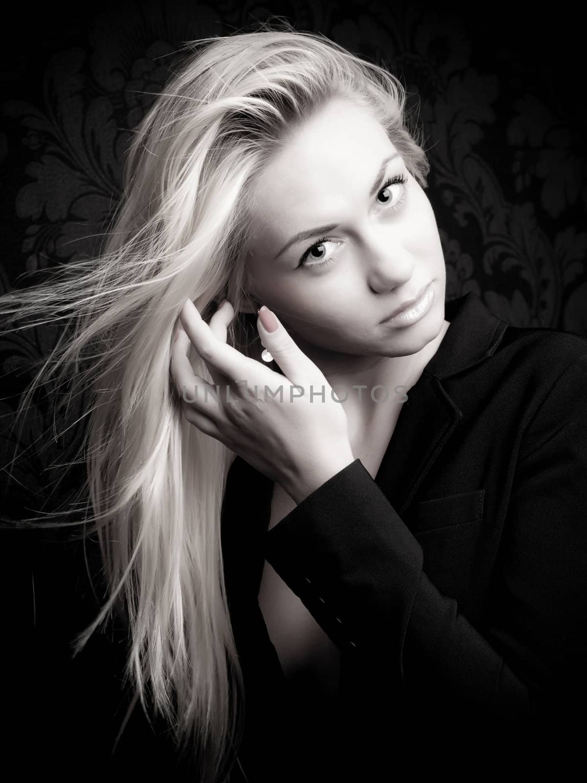 Blonde model stroking hair, black and white