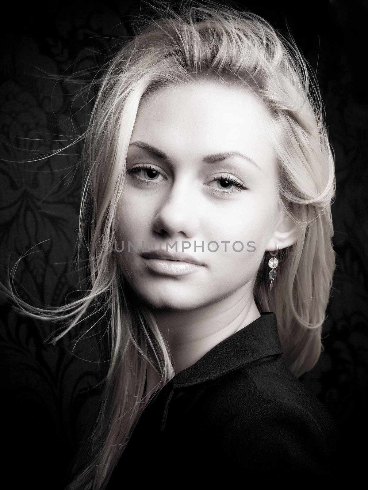 Portrait of a young blond model with sexy look