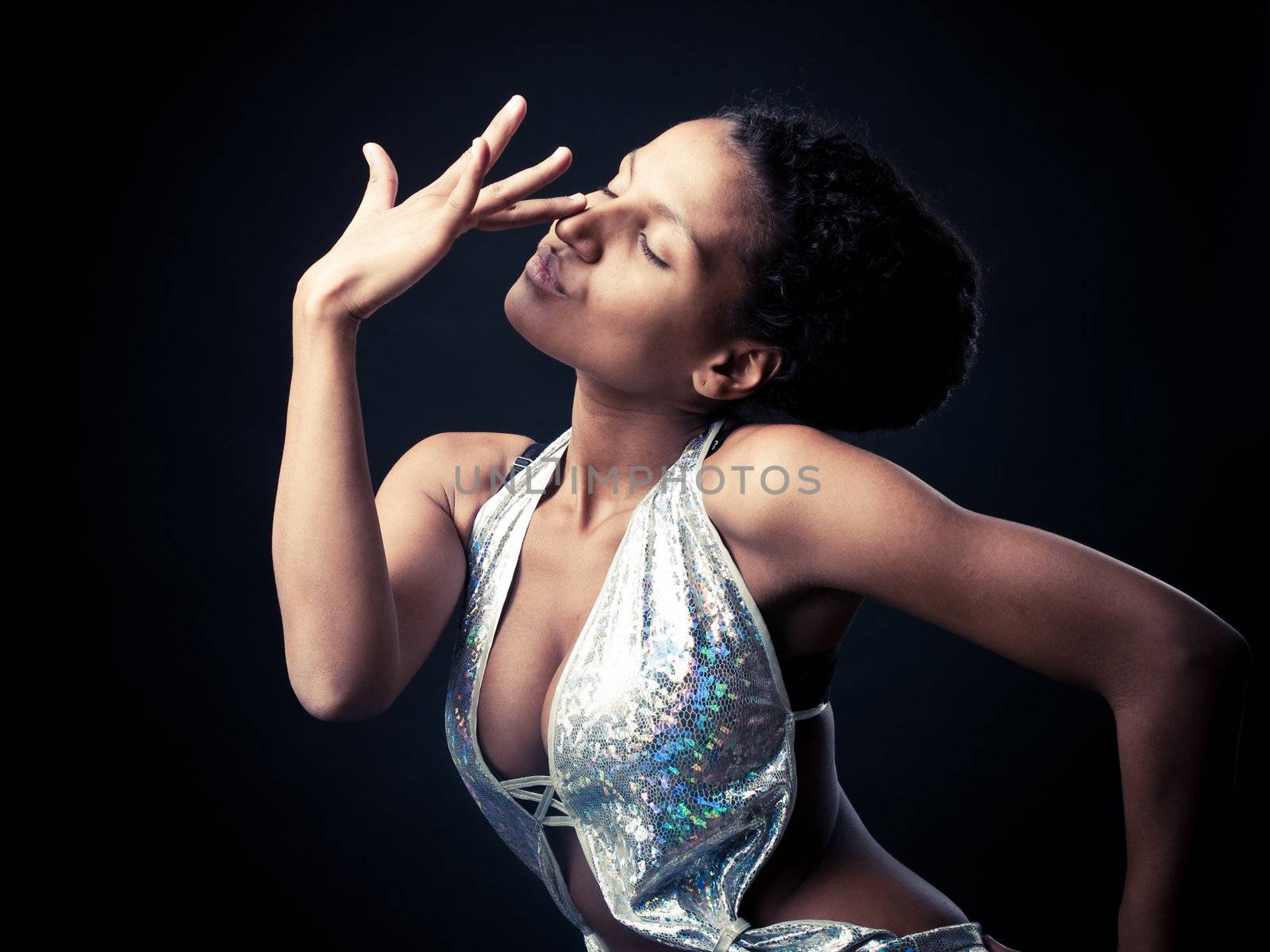 Sexy African go-go dancer striking a sensual pose