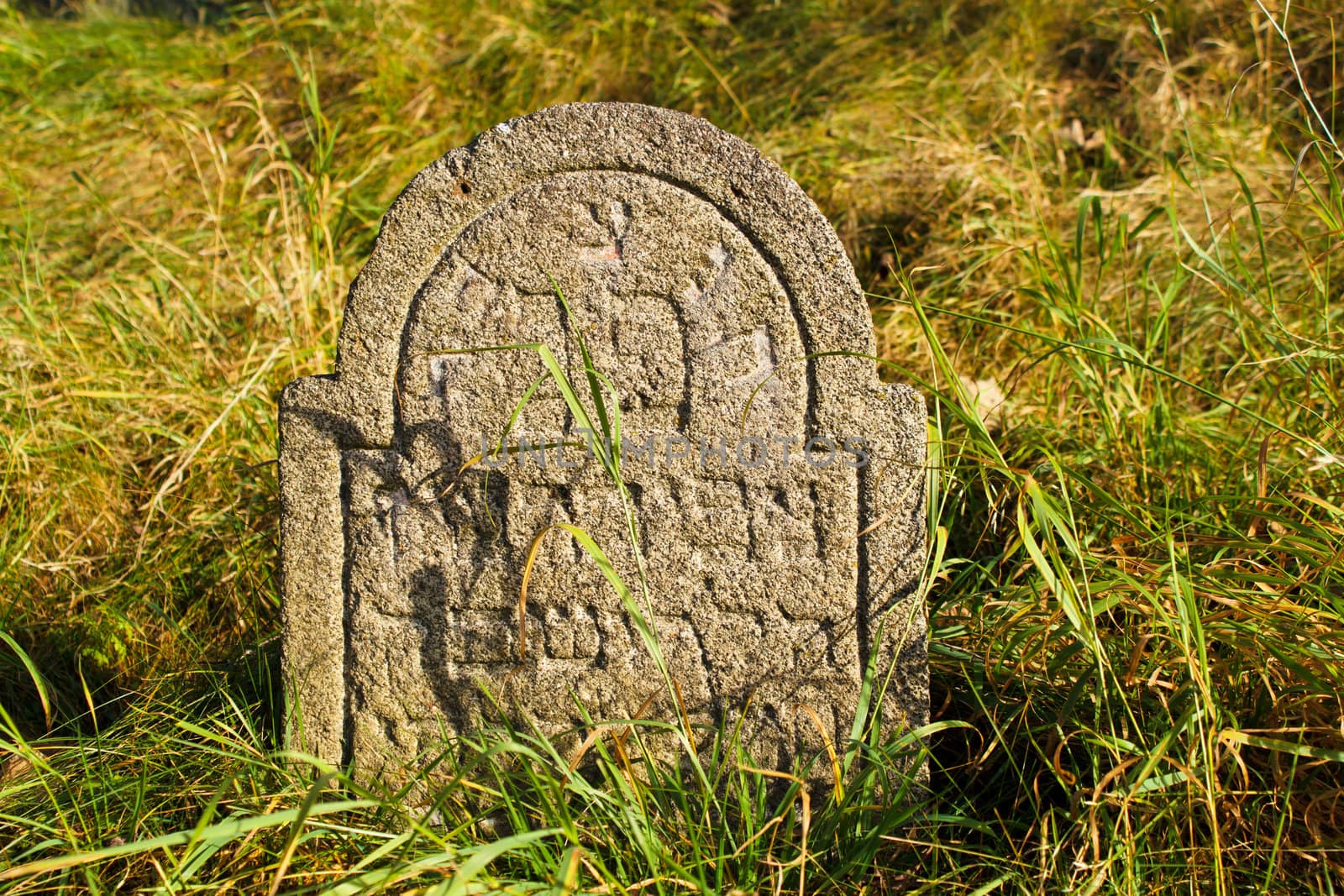 detail of tomb on forgotten and unkempt Jewish cemetery with the strangers