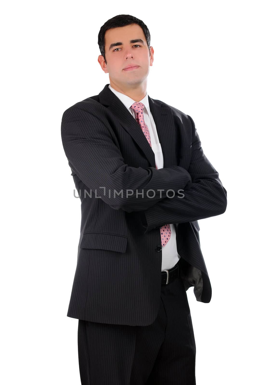 Portrait of a young confident businessman with hands crossed in a dark open suit