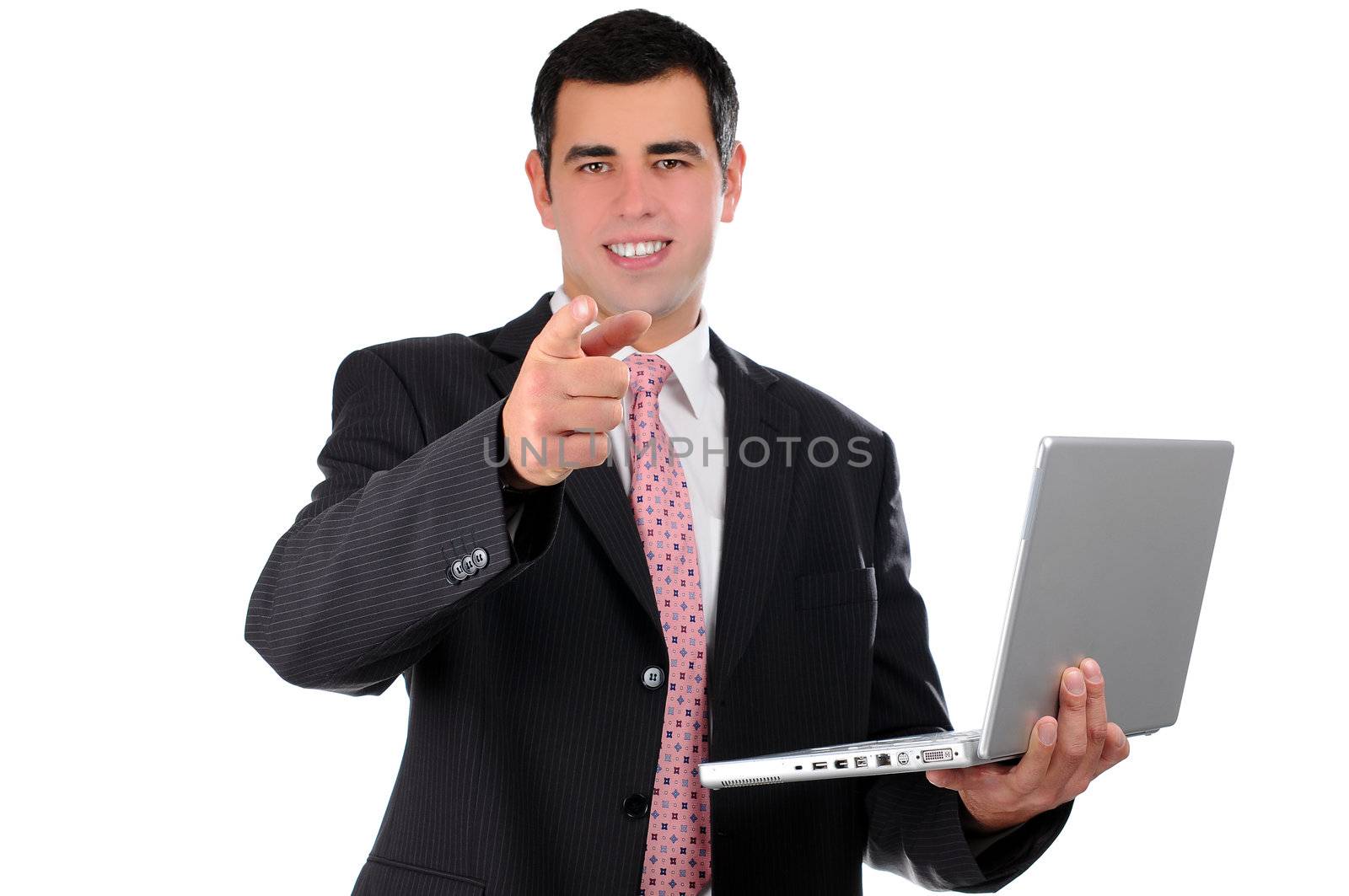 Close up of young businessman holding laptop pointing finger forward