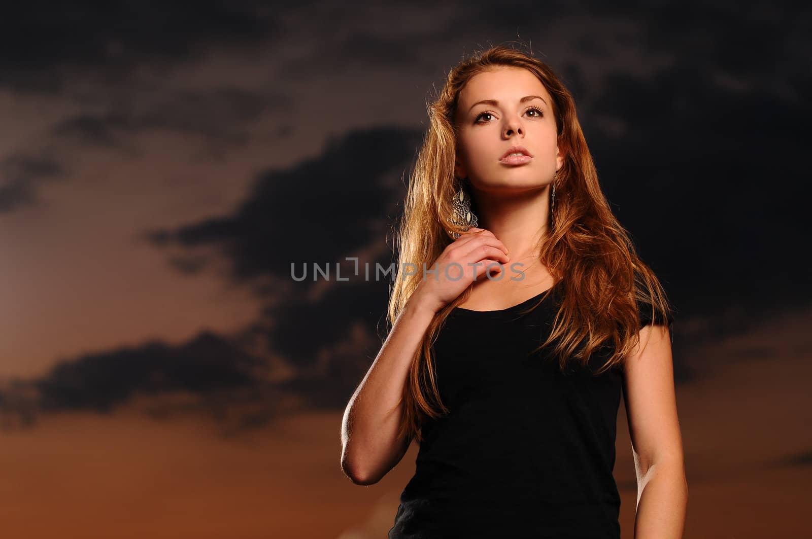 Portrait of a young attractive woman in a black shirt at dusk