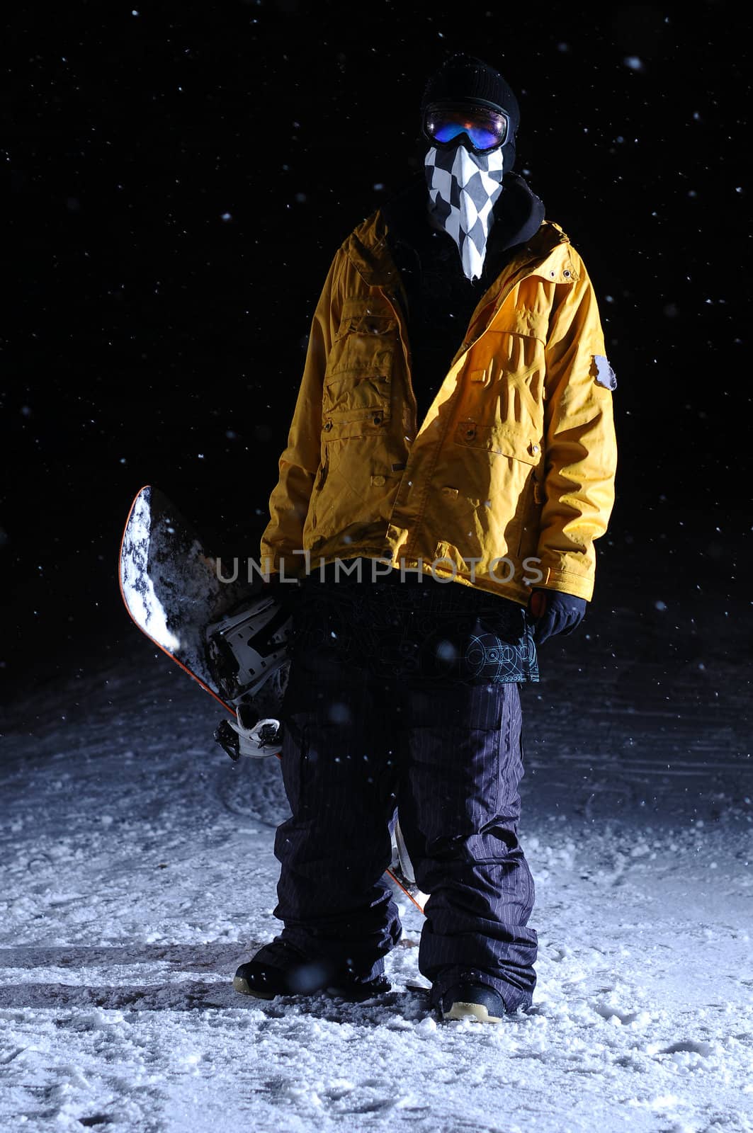 Portrait of a snowboarder standing at night by gravityimaging1