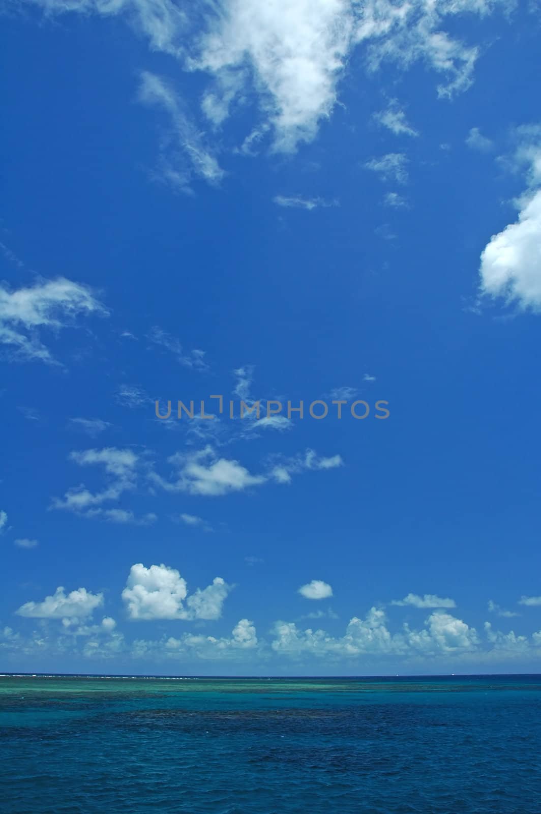 ocean scene, blue sky with white clouds, great barrier reef