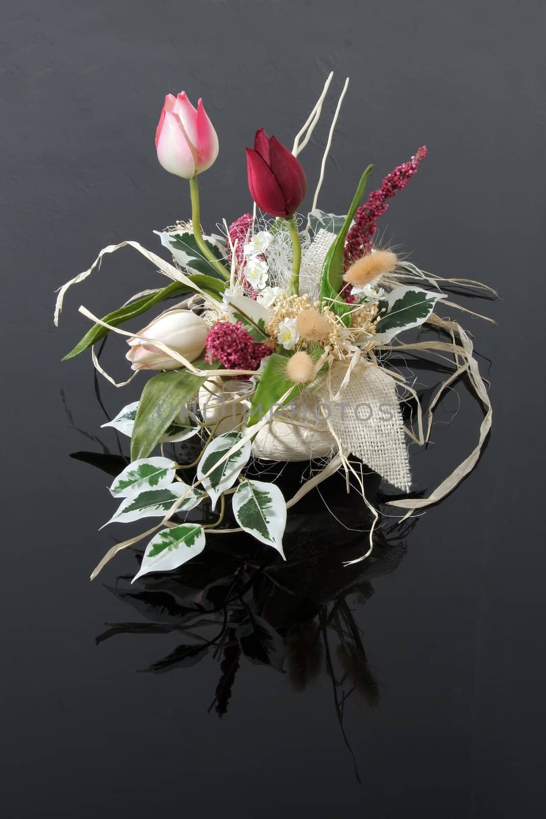 artificial flowers on black reflective background, used for several occasions including wedding