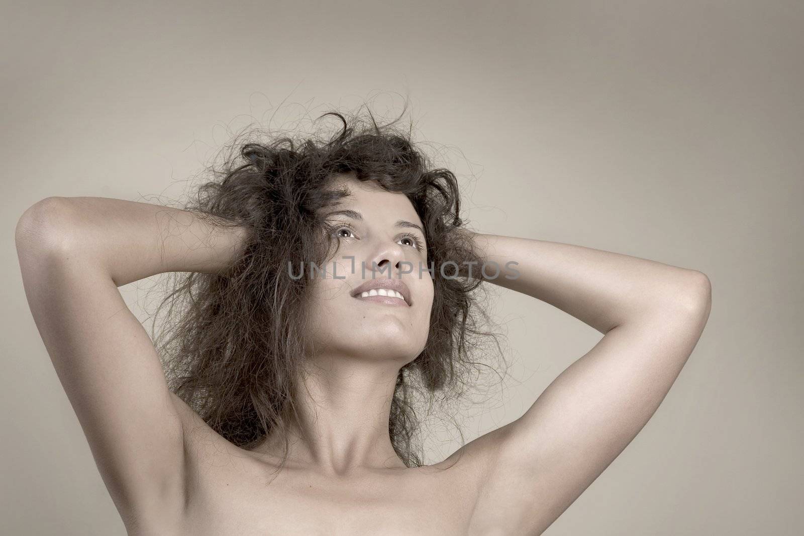 Beautiful face of young woman with curly hairs by VictorO