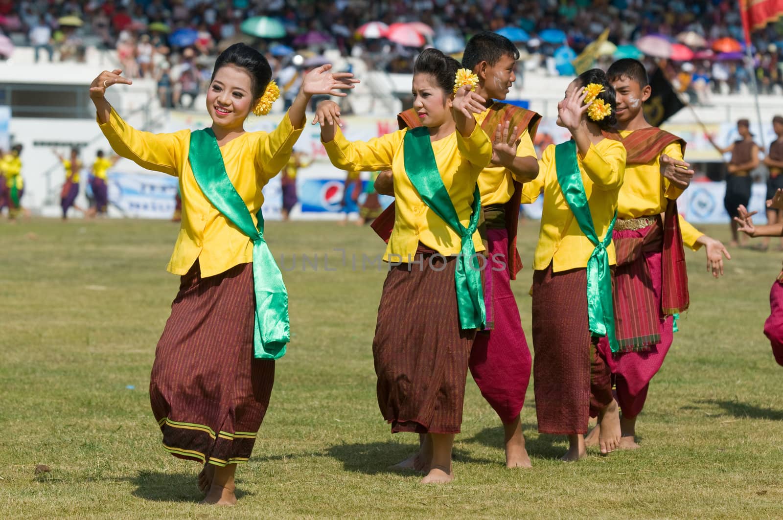 SURIN - NOVEMBER 21: Dancers in traditional farmer's outfits during The Annual Elephant Roundup on November 21, 2010 in Surin, Thailand.