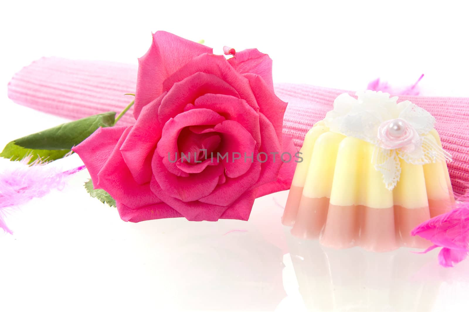 a rose and a soap pie on a white background