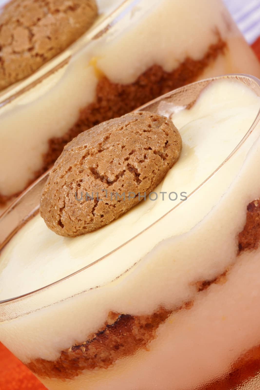 Close-up of vanilla custard and amaretti dessert served in glass cups. Selective focus.