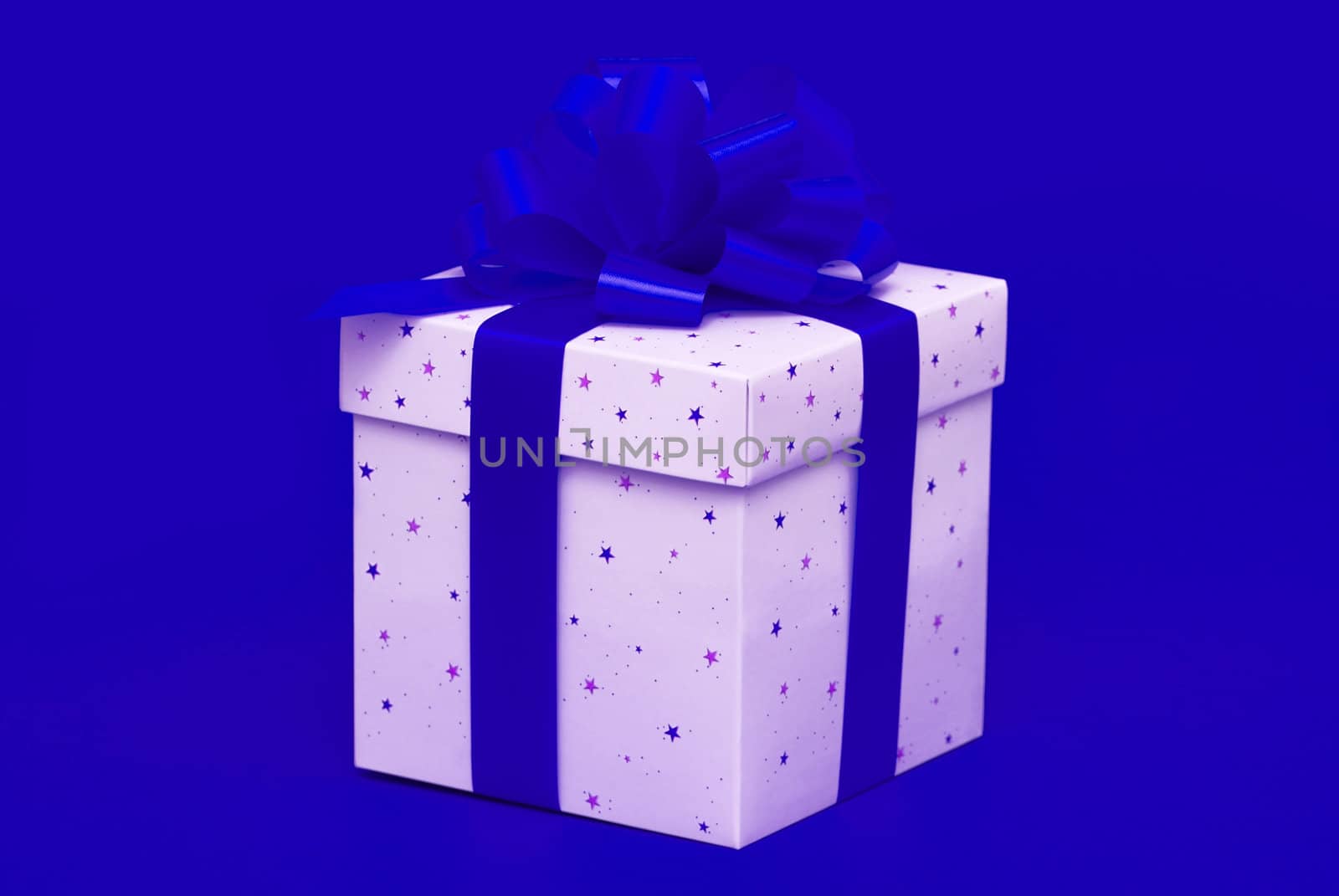 Christmas gift with blue ribbon isolated on red background
