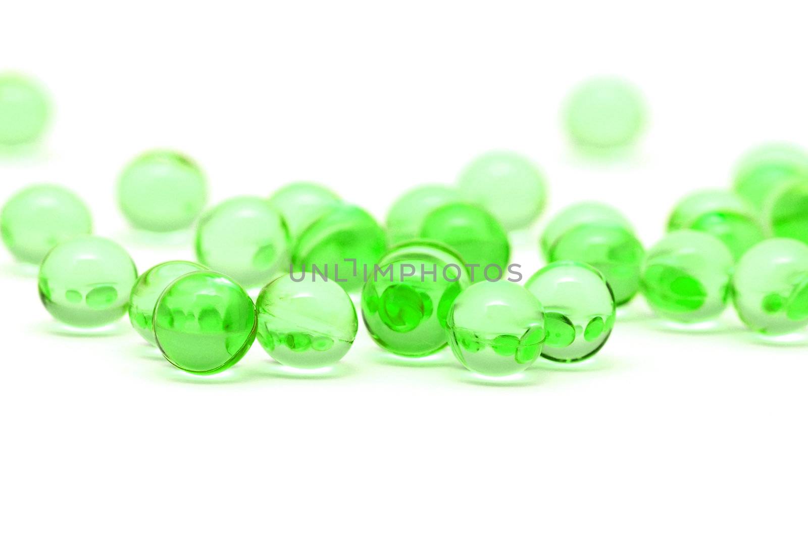 Transparent green capsules isolated on white