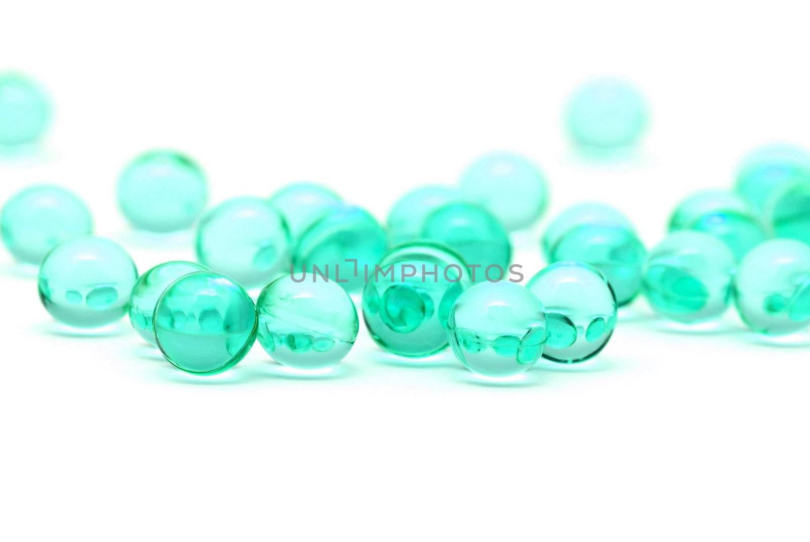 Transparent blue capsules isolated on white