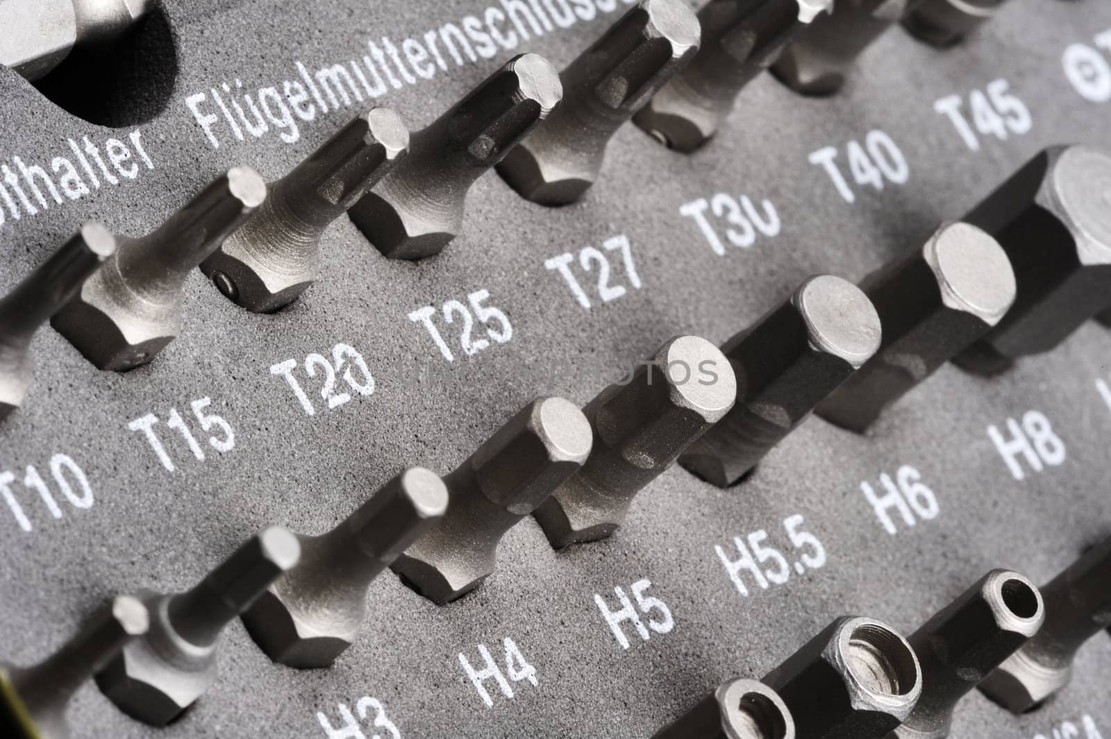 Closeup of lines of screwdriver heads in a workman's toolbox