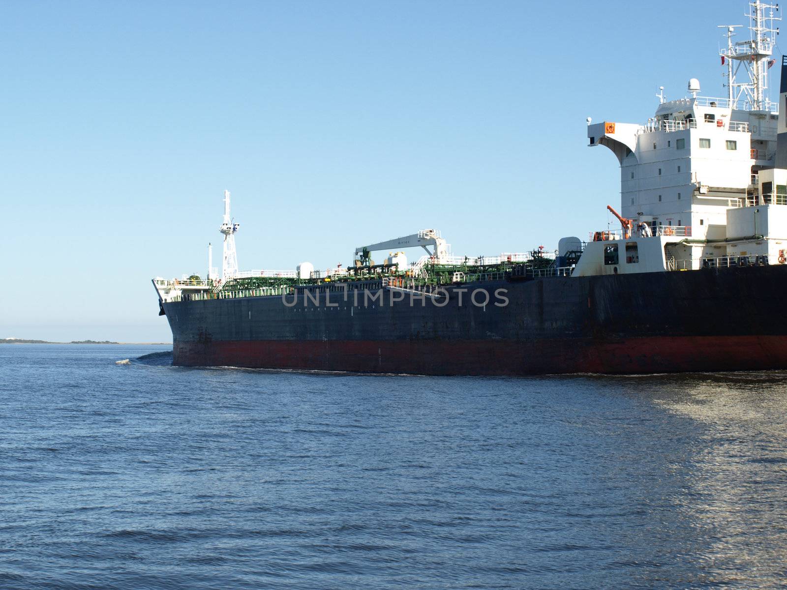 A large cargo ship heading out to sea