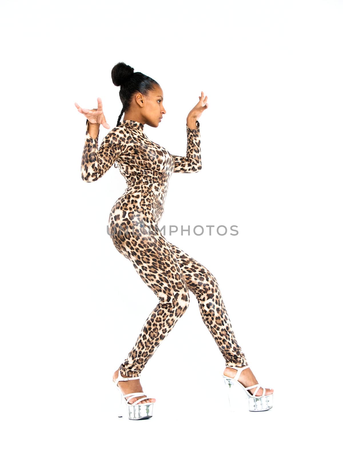 African dancer in leopard suit striking a dance pose