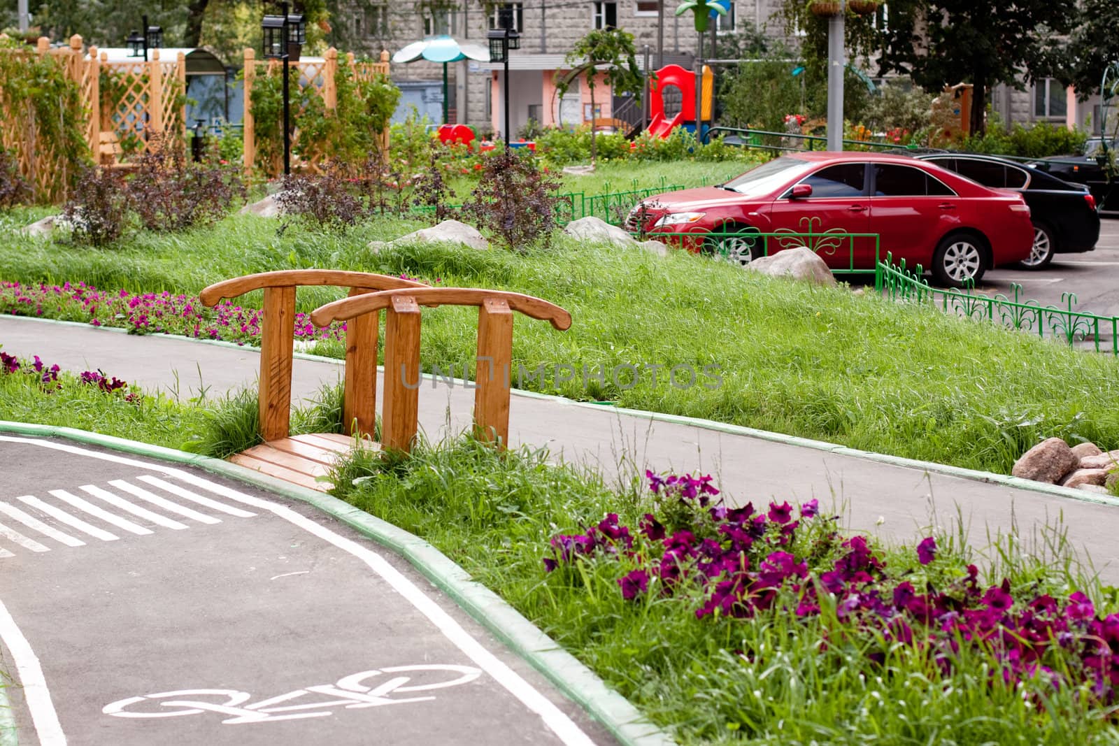 A small wooden bridge in a city yard 
