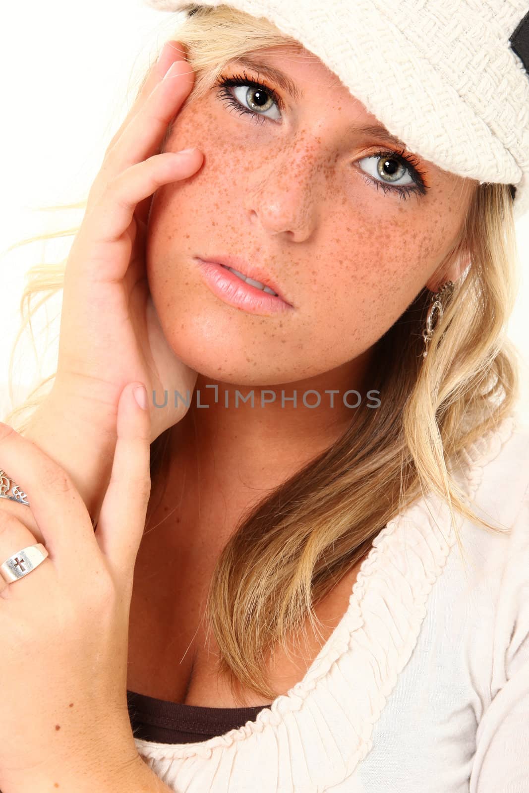Beautiful young woman with freckles and blond hair over white.
