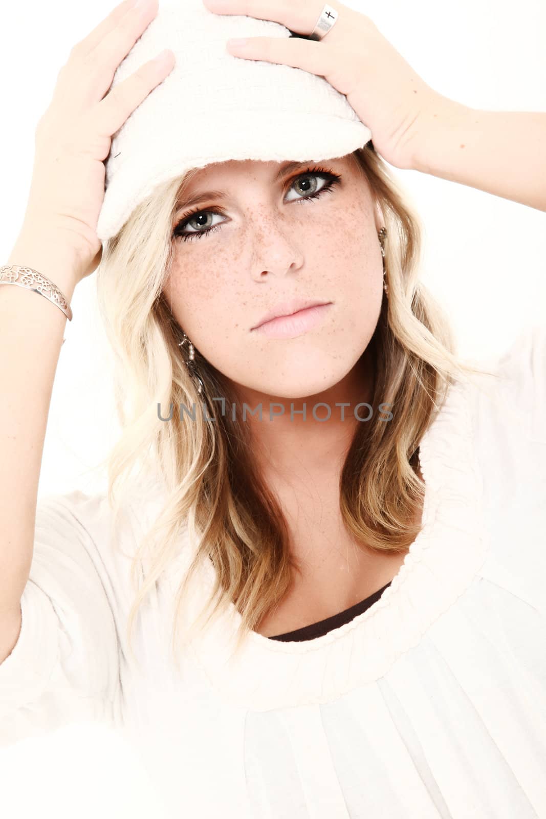 High key portrait of beautiful young woman with freckles.