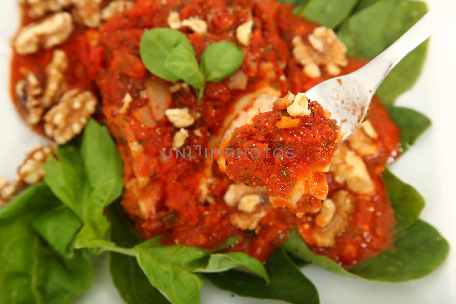 Gorgonzola, Italian blue cheese, with walnuts and basil rolled in lasanga noodles on bed of spinach.