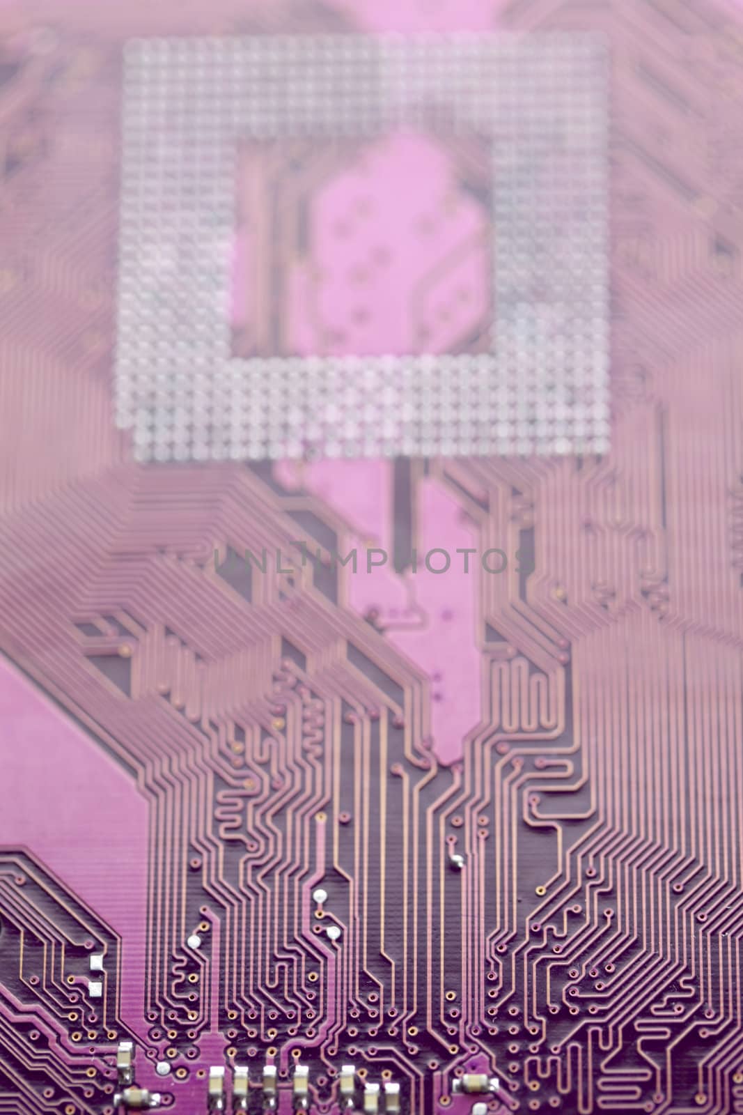 A close up shot of the backside of a computer circuit board, also known as a motherboard.