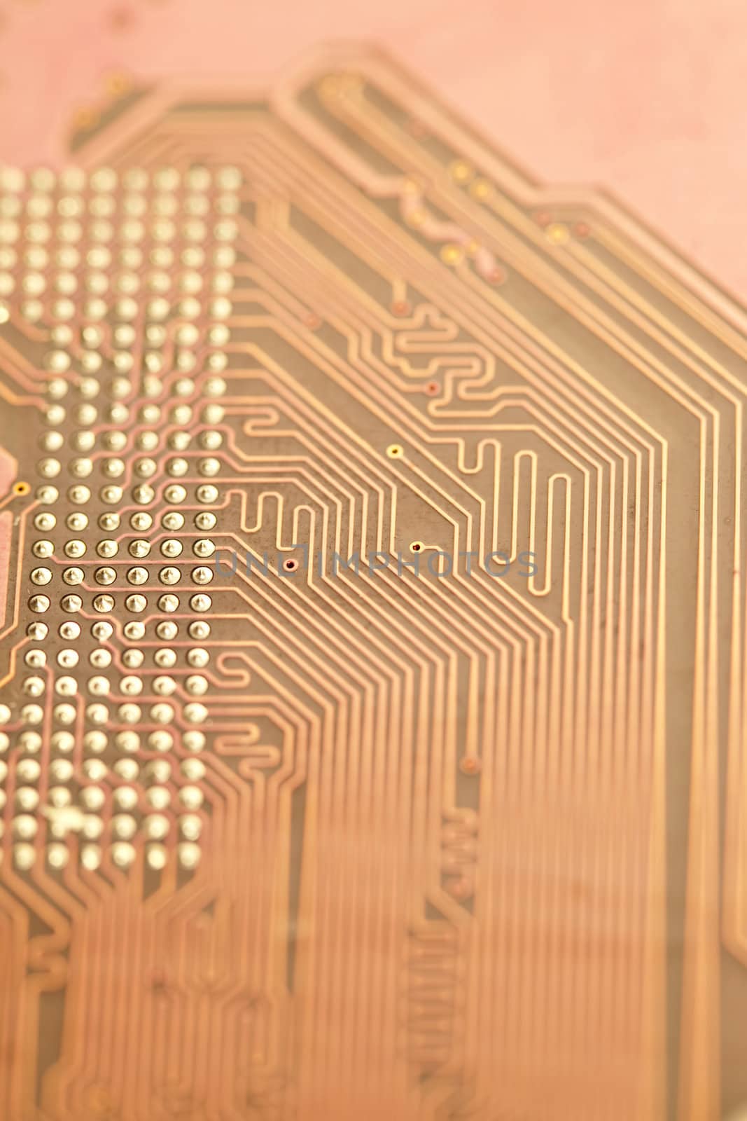 A close up shot of the backside of a computer circuit board, also known as a motherboard.