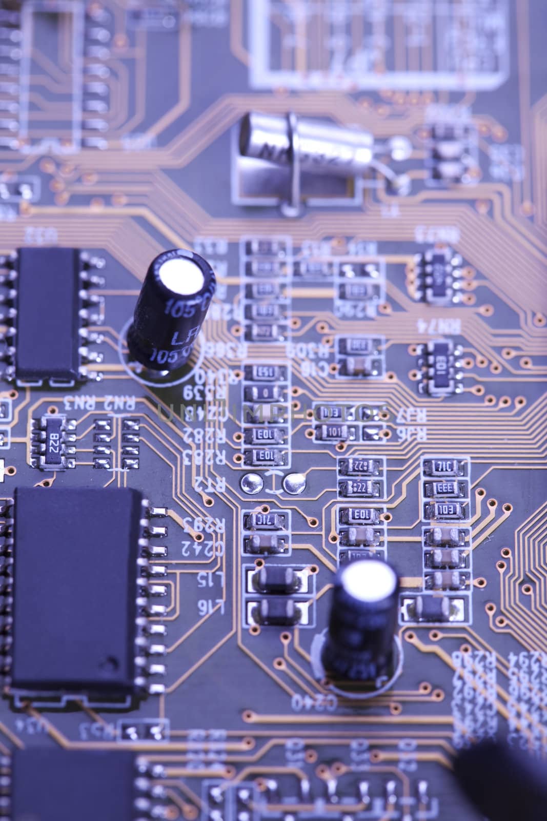 A close up shot of the backside of a computer circuit board, also known as a motherboard.