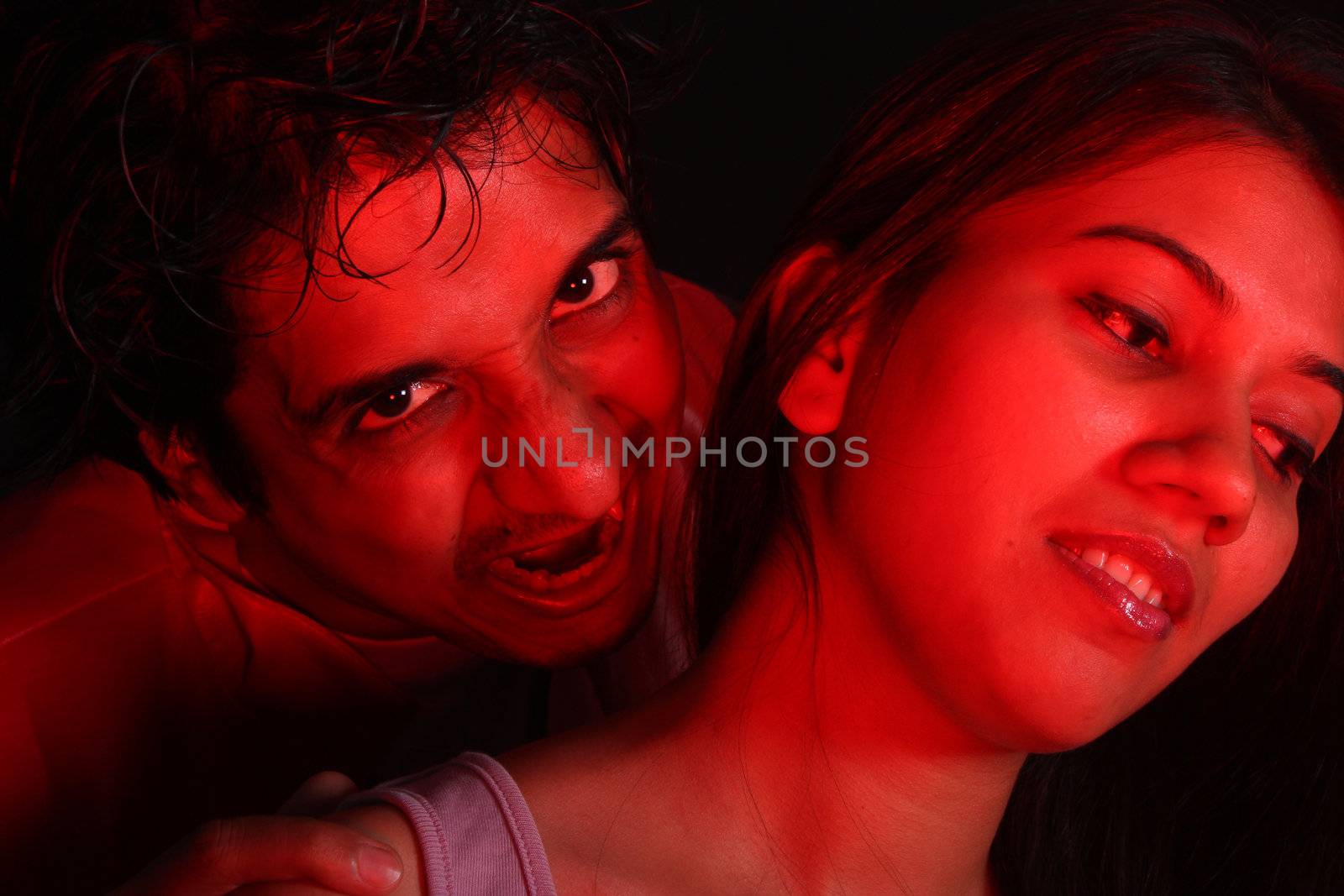 An Indian vampire about to bite a beautiful woman for blood.