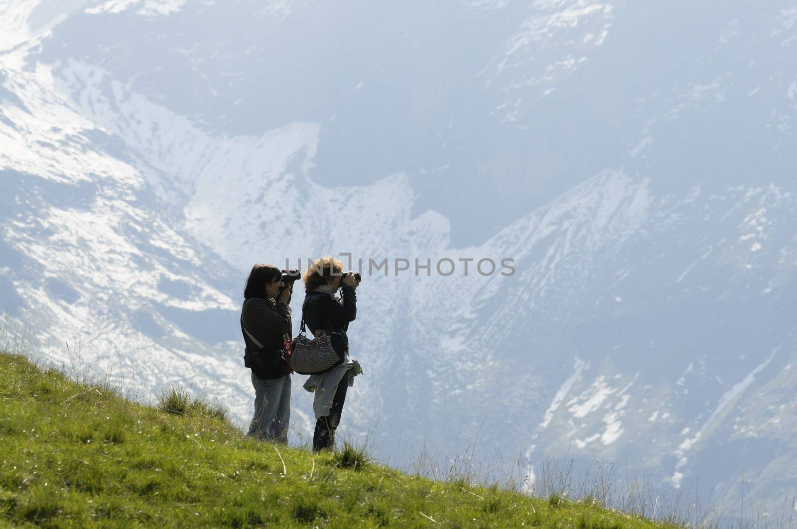Women taking pictures of mountains by fahrner