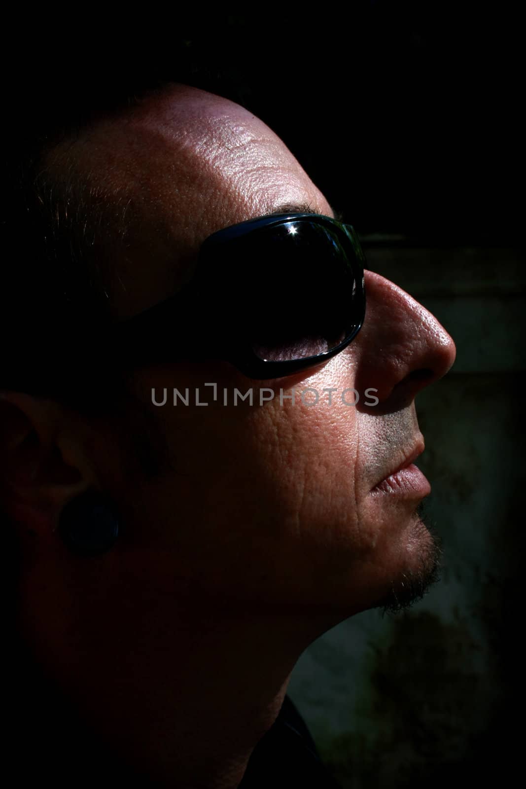 Man with sunglasses in low key shot