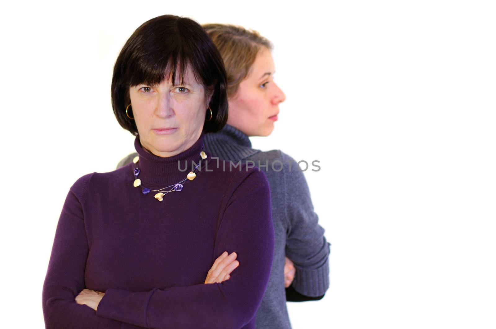Mother and doughter standing back to back after conflict. Isolated over white background.