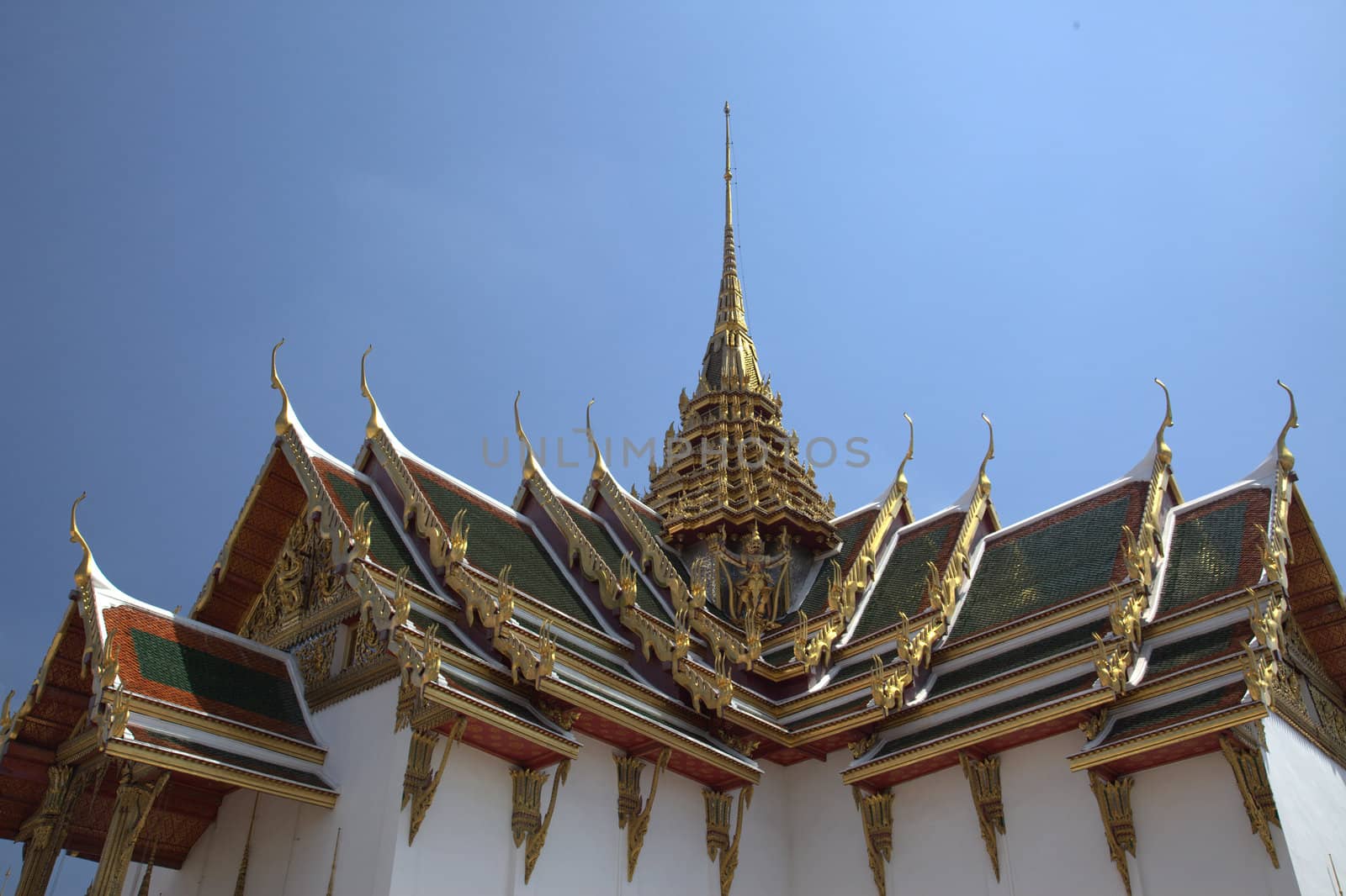 Roof of a temple with gods against a blue sky - horizontal
