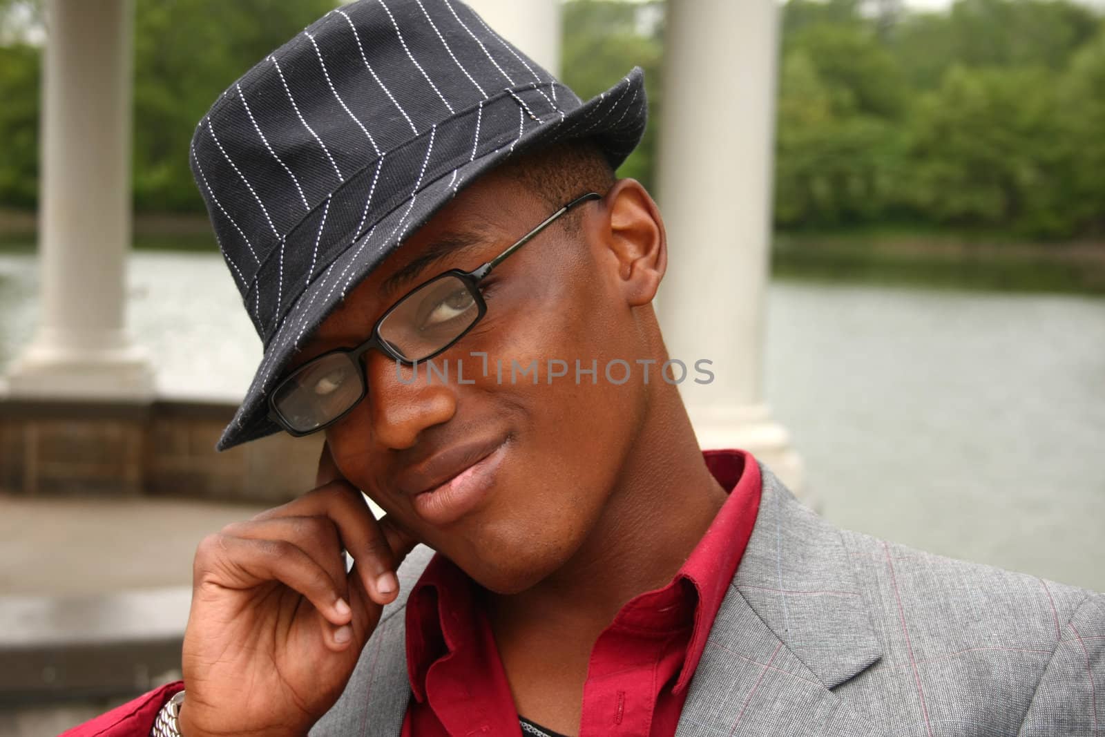 A homosexual man posing with his hand on the side of his face