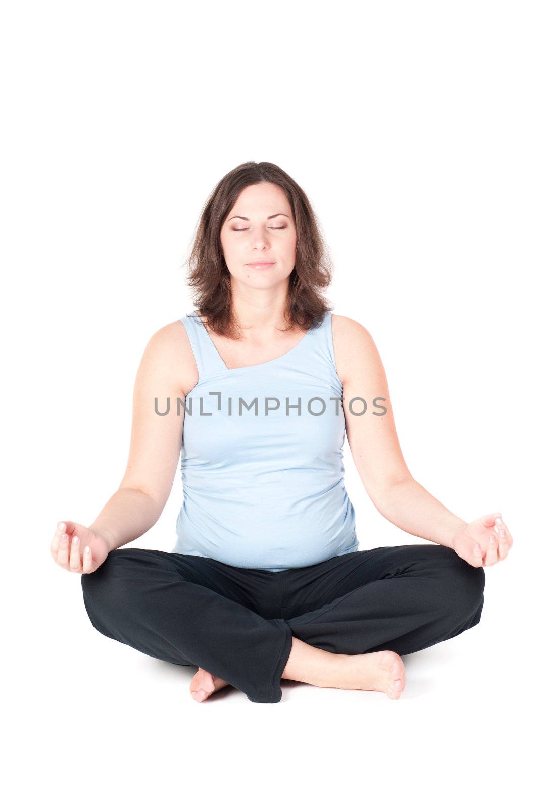 Portrait of pretty pregnant woman practicing physical exercise isolated on white