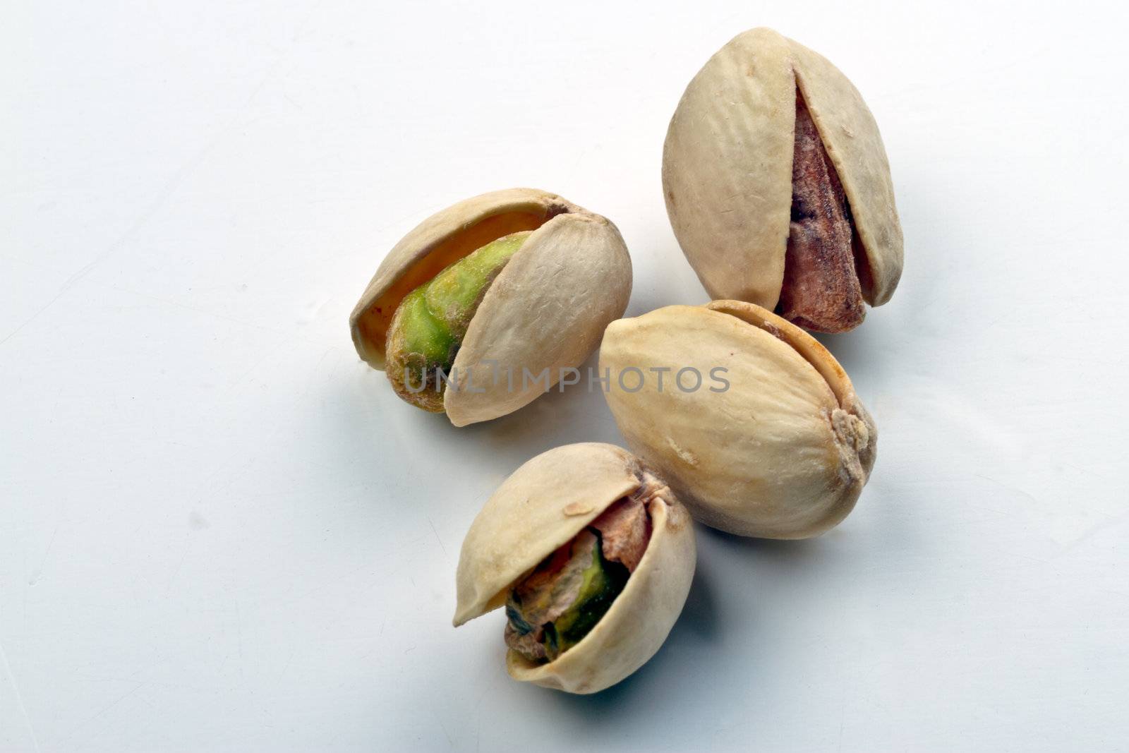 Four hole pistachio nuts on white background