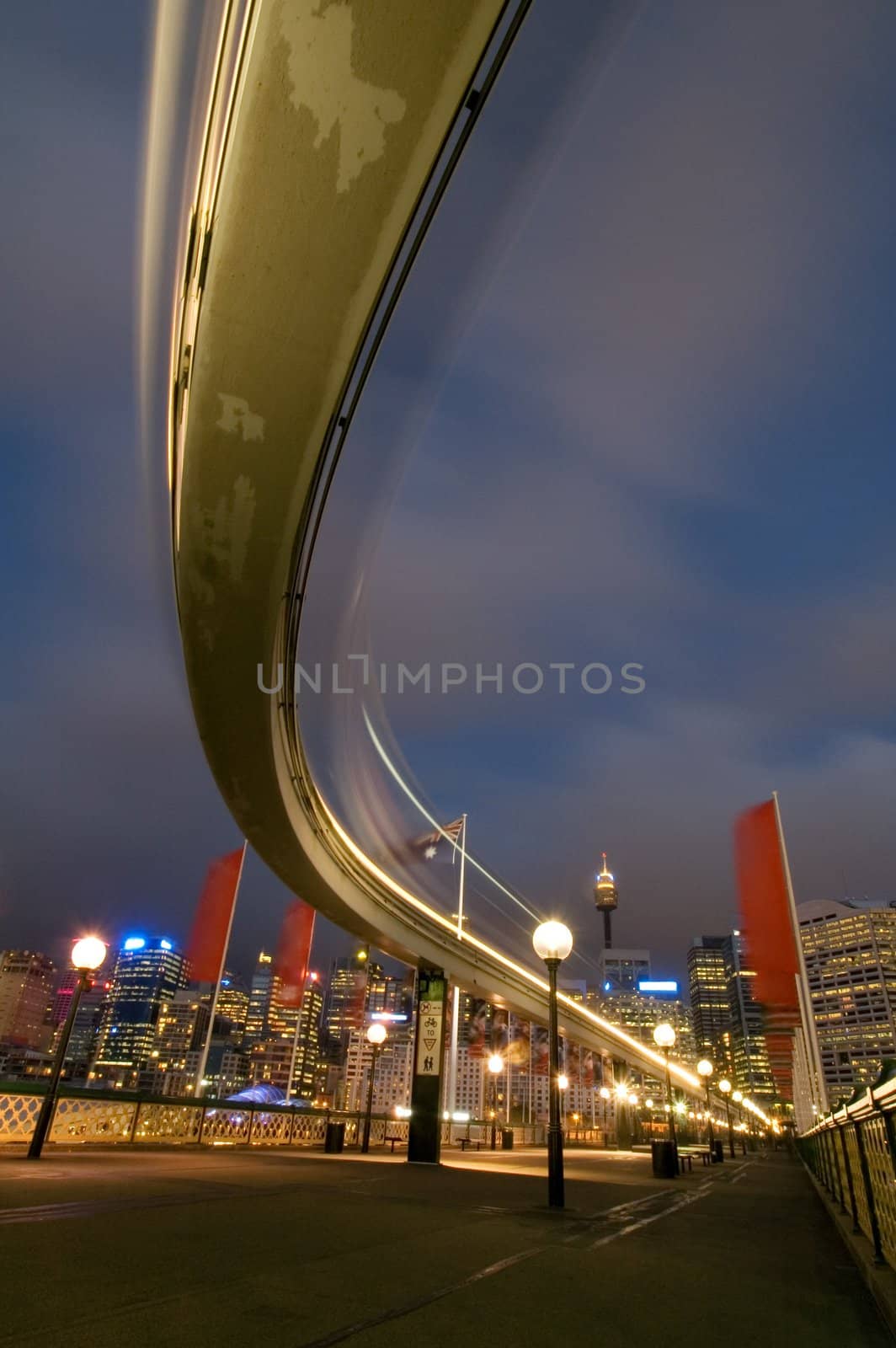 Sydney monorail, blurred train in motion, pyrmont bridge, cbd in background